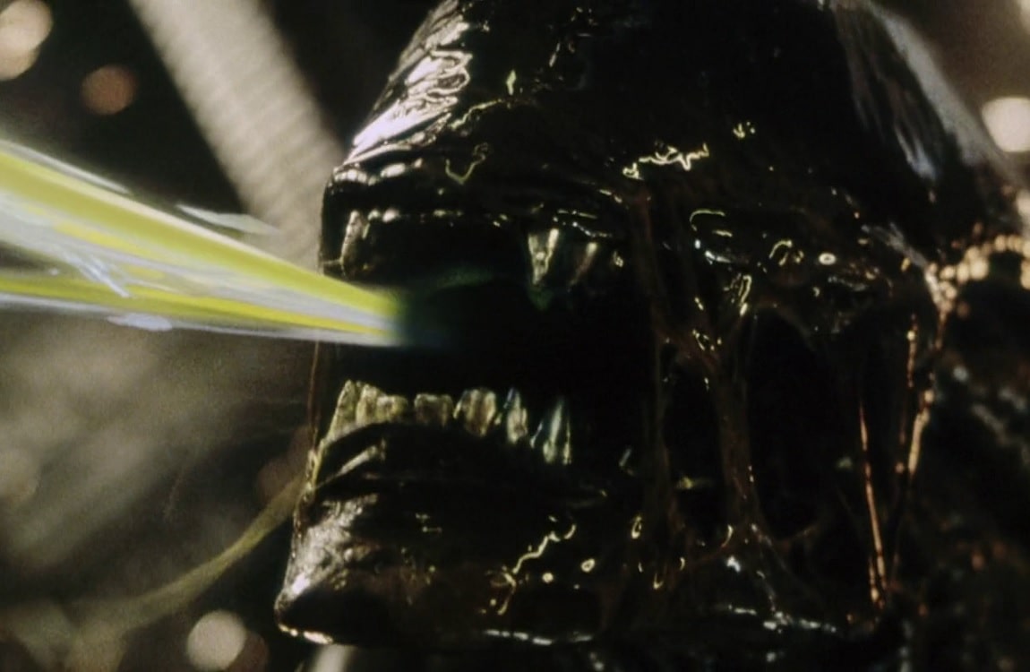 The Cloned Xenomorph Warrior from Alien: Resurrection spits acid into the face of Christie