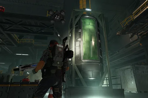 A Colonial Marine standing in front of a sealed Acidium tank at Storr's Boon in Aliens Fireteam Elite 2