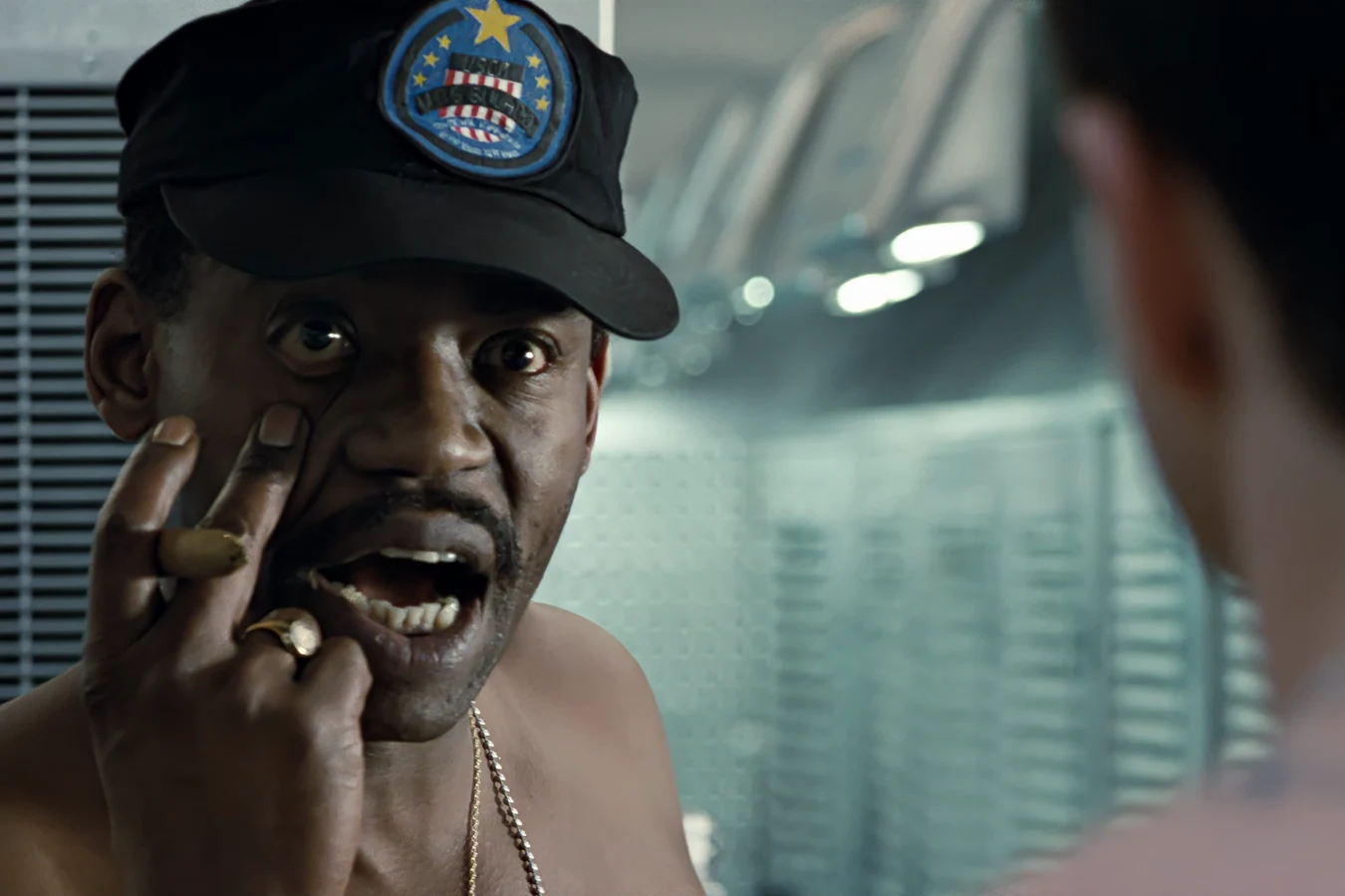 Apone pulling his eyelid down with a cigar after waking the Sulaco squad in Aliens