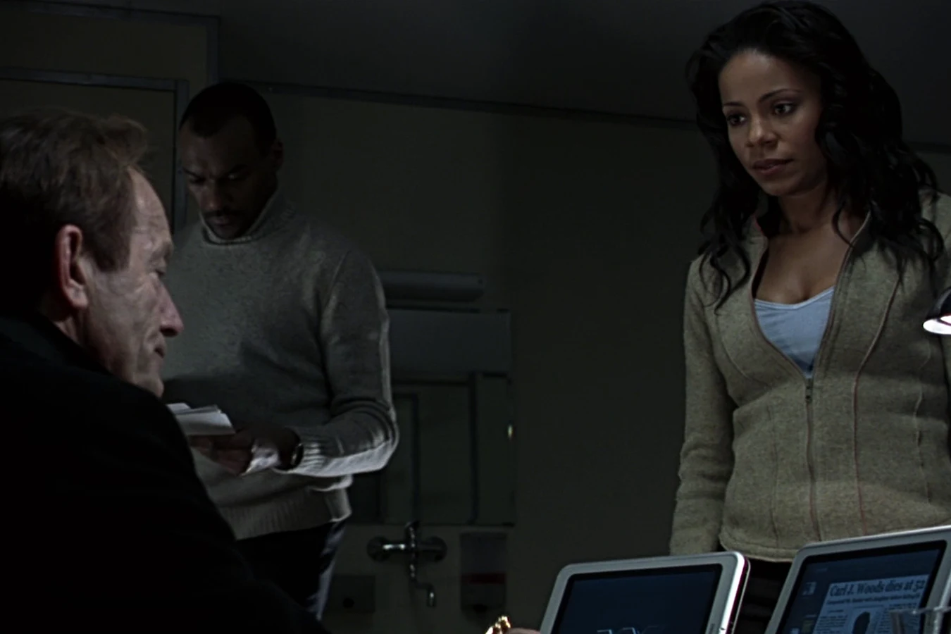 Alexa Woods sits across from Charles Bishop Weyland during the expedition briefing