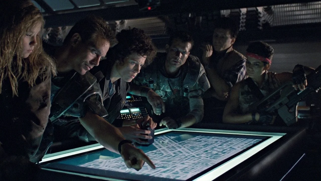 The Colonial Marines from Aliens examining the Hadley's Hope colony map