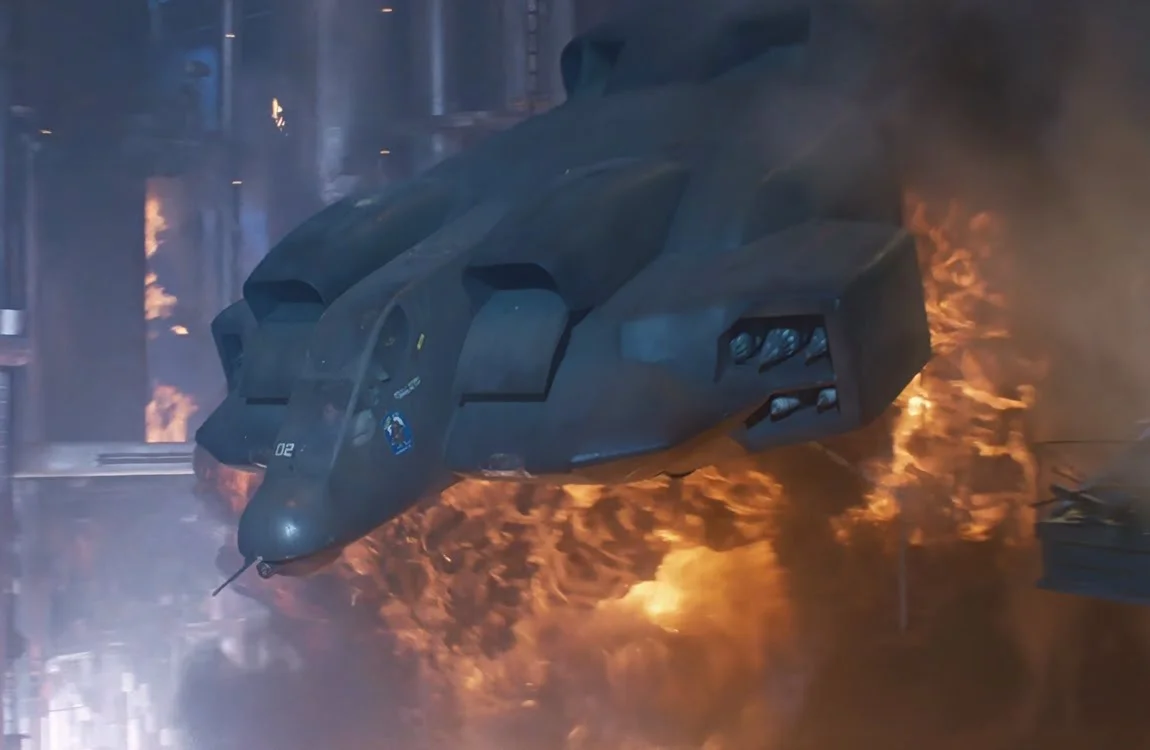 The dropship in the atmosphere processor with an explosion in the background