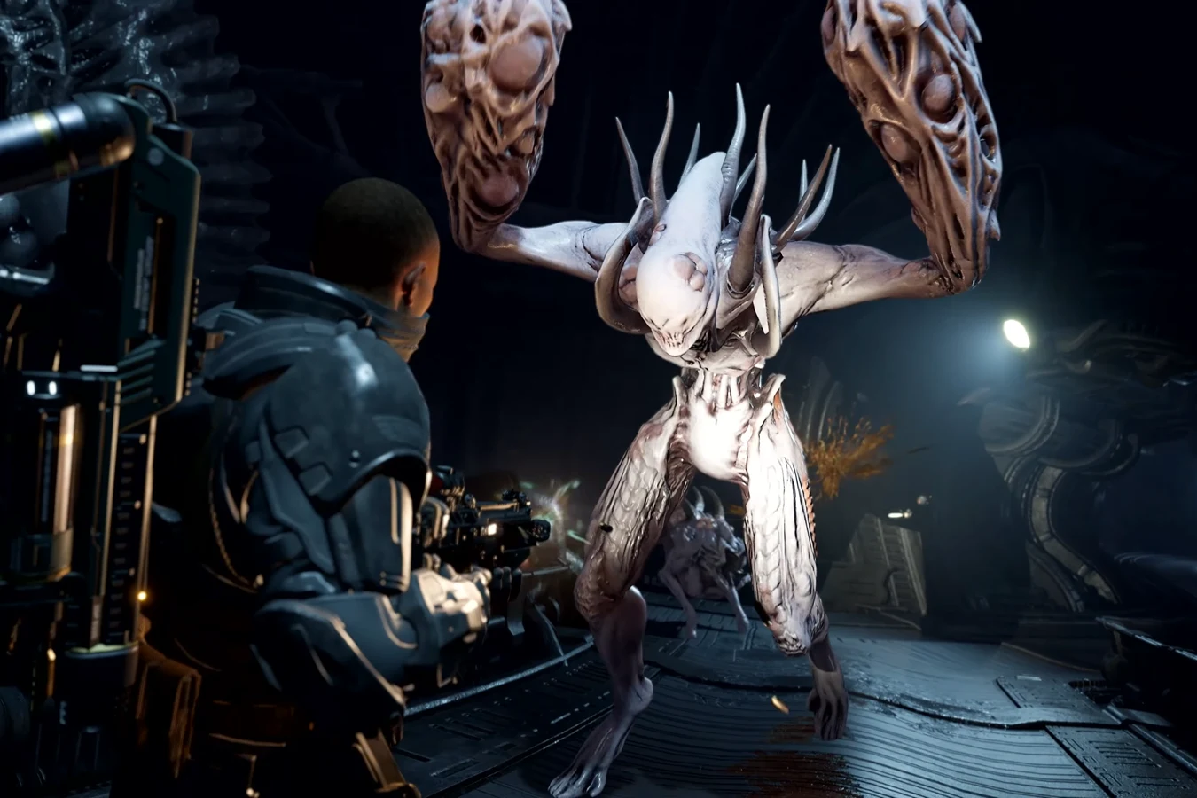 A Colonial Marine firing on a Striker in a dark corridor in Aliens: Fireteam Elite 2
