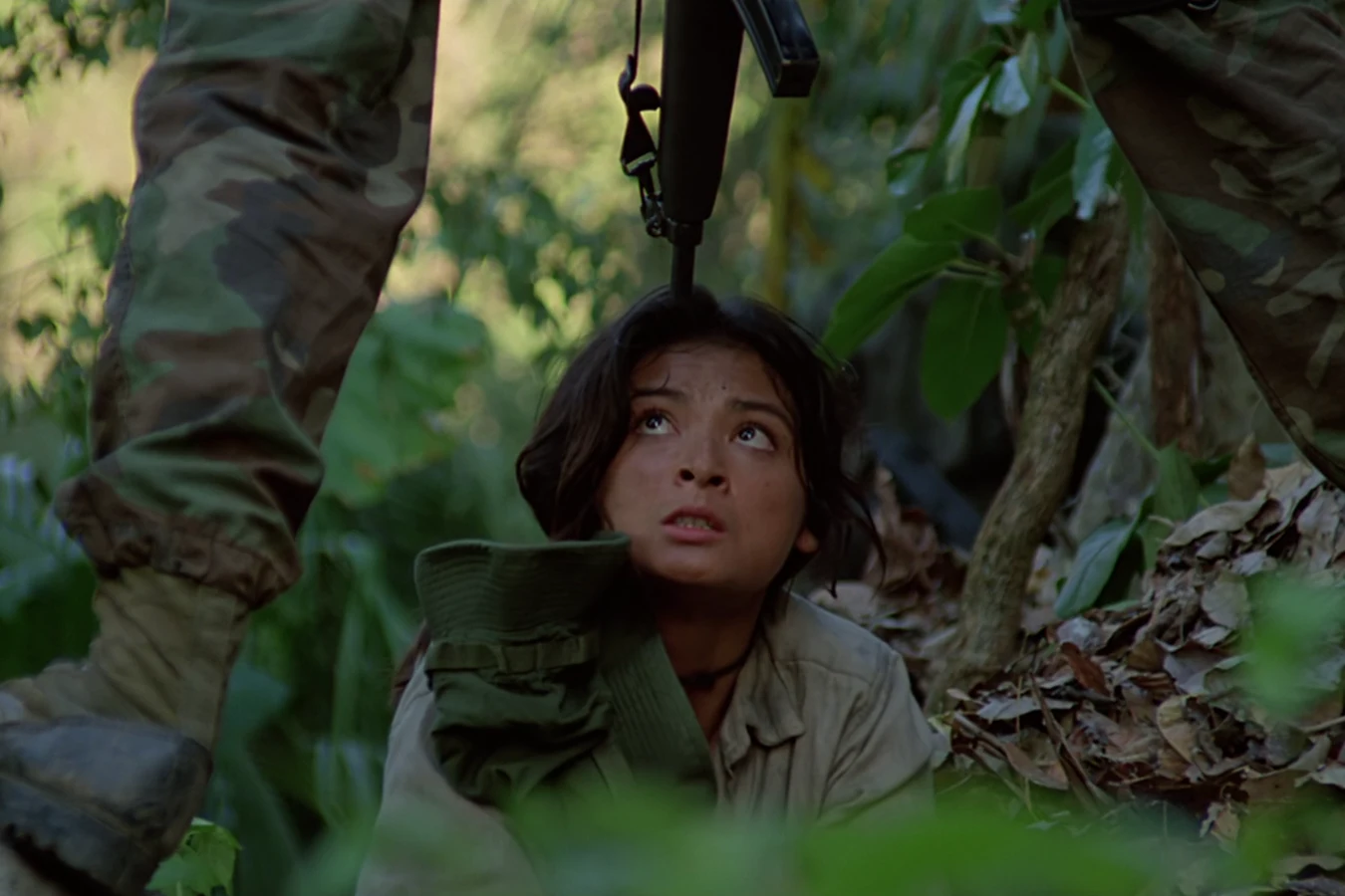 Anna Gonsalves crouched on the jungle floor, looking up at a commando standing over her with a rifle