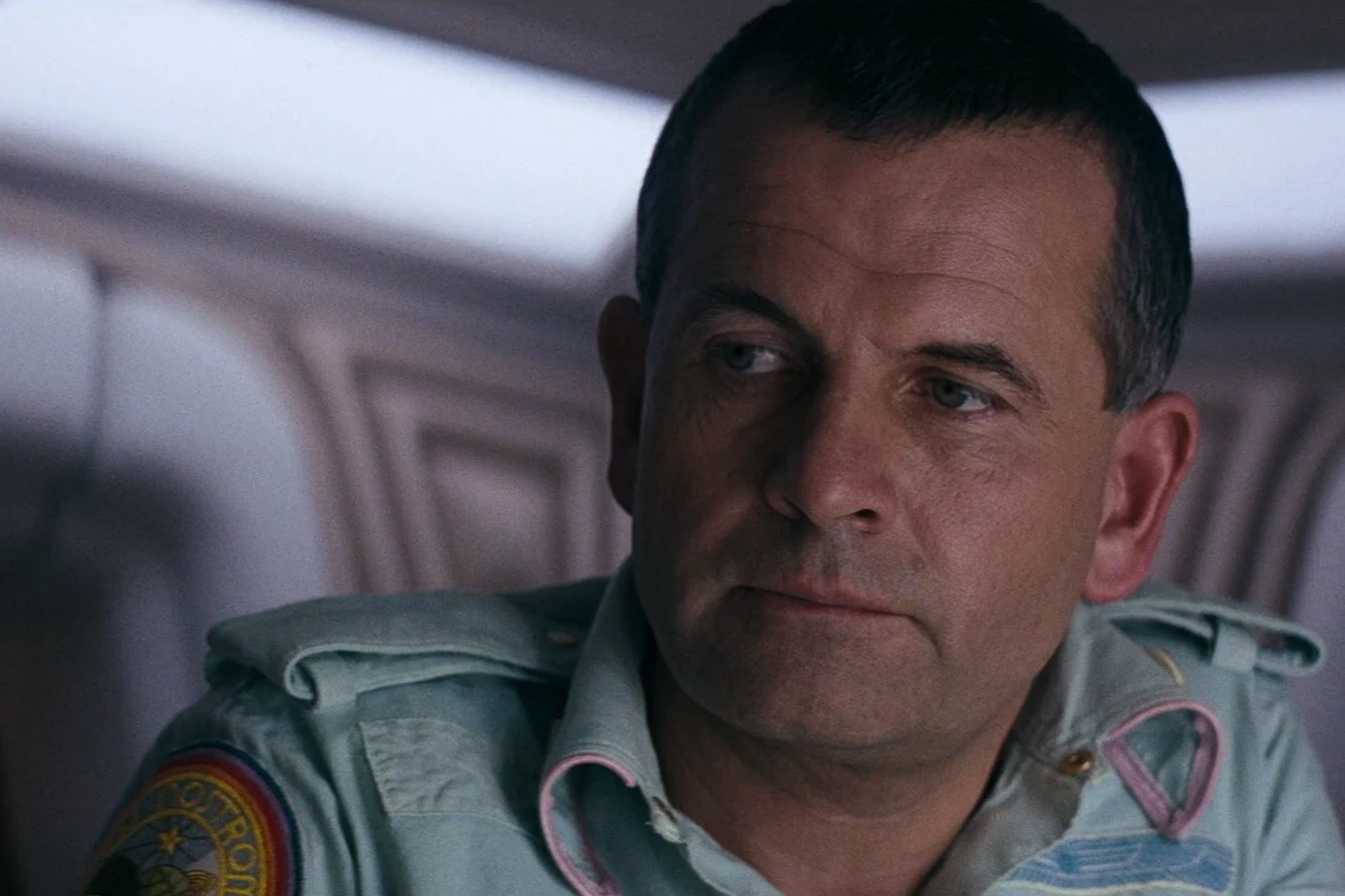Ash in his blue Nostromo shirt after the crew woke from hypersleep