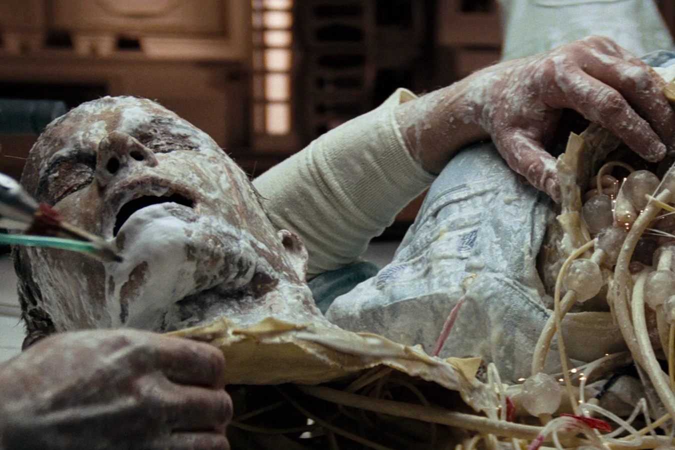 Ash's opened torso and android internals on the Nostromo mess table