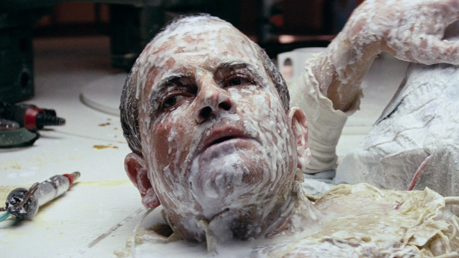 Ash's wrecked head on the Nostromo mess table in Alien
