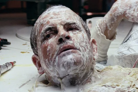 Ash's wrecked head on the Nostromo mess table in Alien