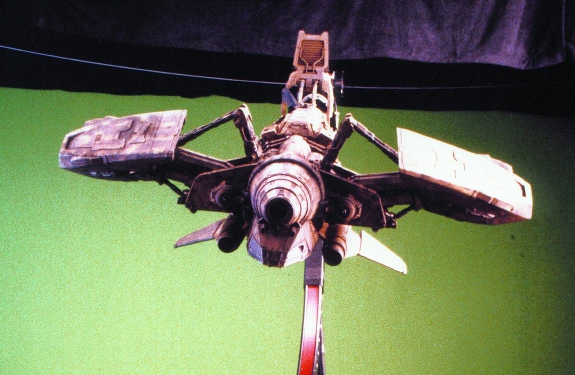 A behind the scenes shot of the Betty with a green screen background