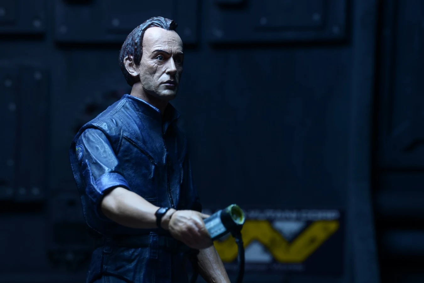 NECA Aliens Series 3 Bishop figure in the Sulaco jumpsuit with a handheld scanner