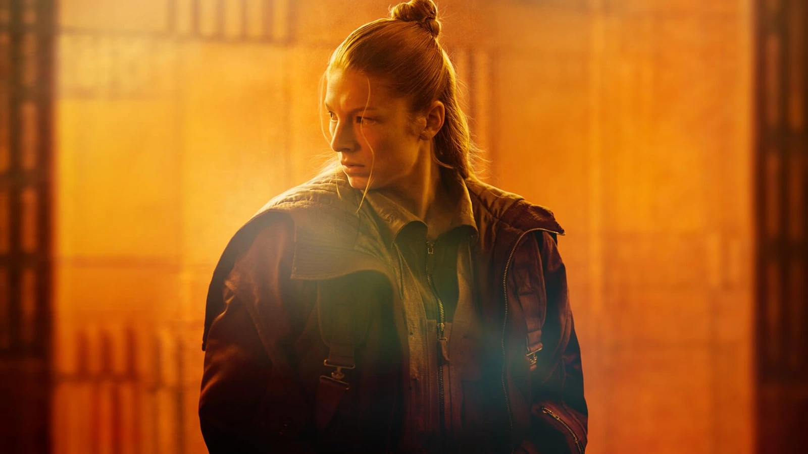 Hunter Schafer as Cora in Blade Runner 2099, standing against amber light
