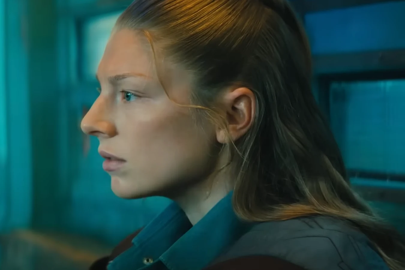 Hunter Schafer as Cora in profile against cyan light in the Blade Runner 2099 teaser