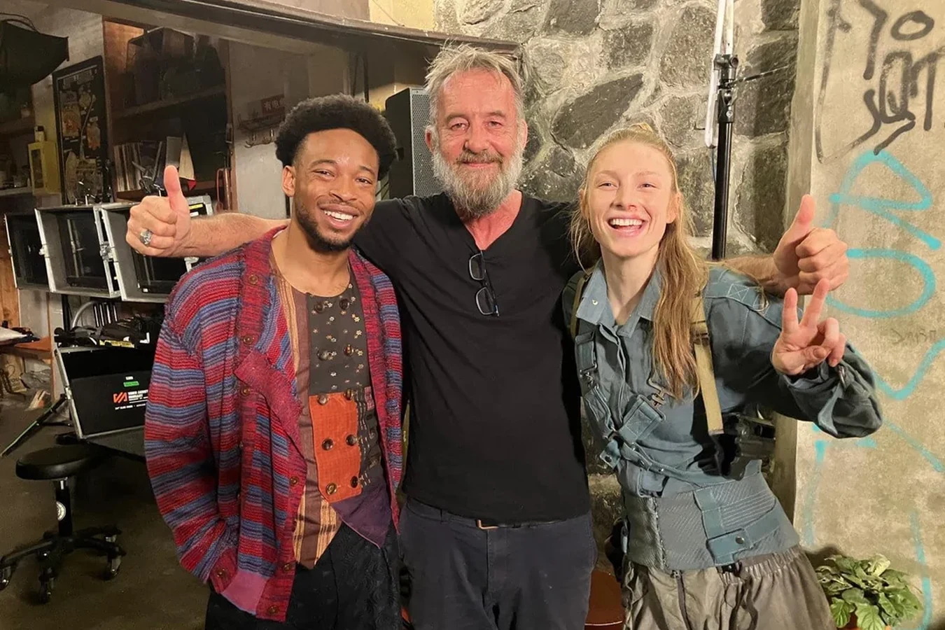 Hunter Schafer in Cora's costume on the Blade Runner 2099 set with two colleagues