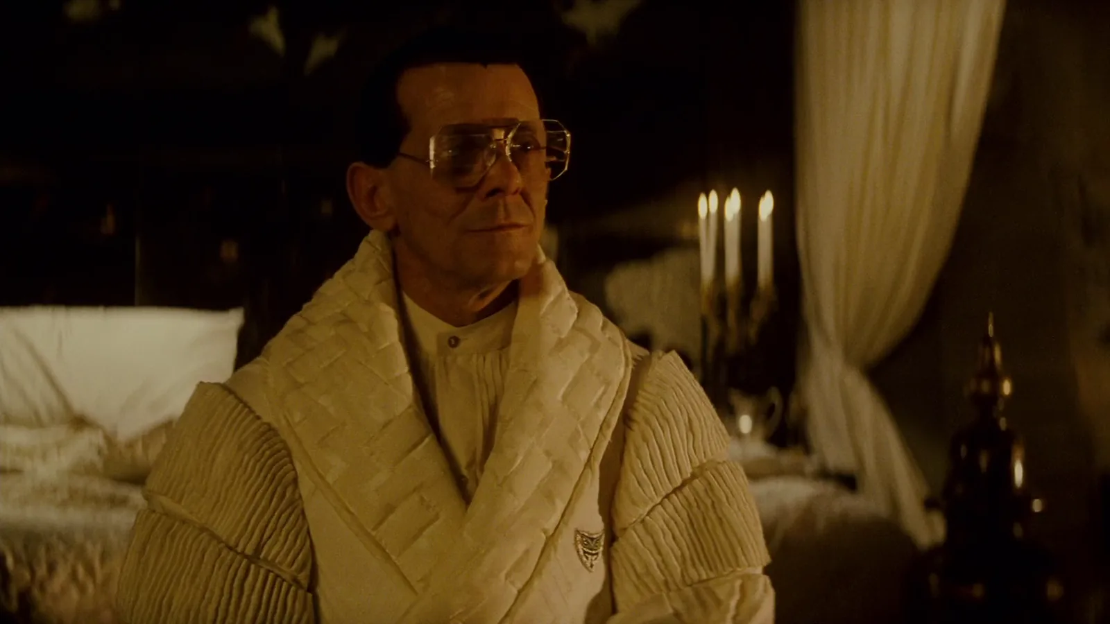 Joe Turkel as Eldon Tyrell in his white quilted robe in his candlelit bedroom in Blade Runner