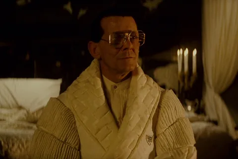 Joe Turkel as Eldon Tyrell in his white quilted robe in his candlelit bedroom in Blade Runner