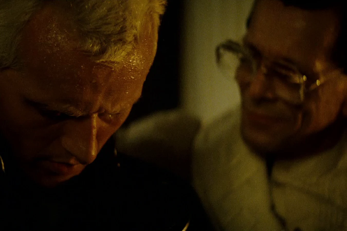 Rutger Hauer as Roy Batty bowing his head beside Joe Turkel's Eldon Tyrell in the candlelit bedroom in Blade Runner