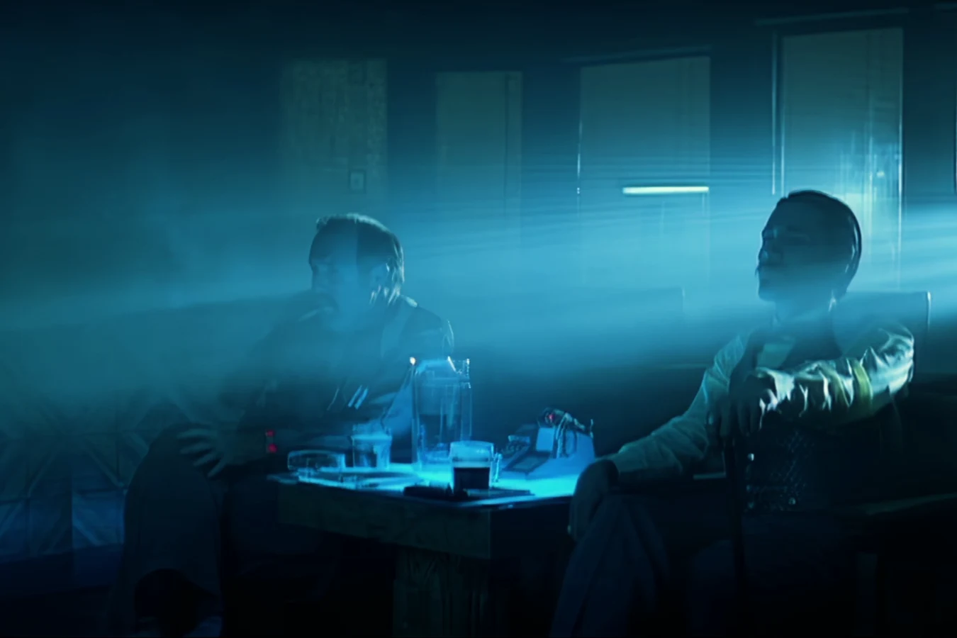 Harry Bryant and Gaff watching a monitor in a smoky LAPD office in a deleted Blade Runner scene