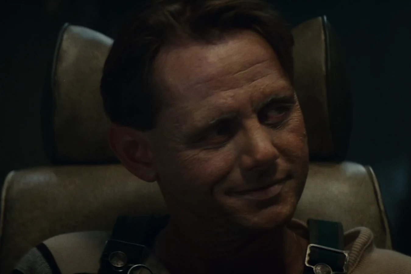 William Sanderson as J.F. Sebastian smiling in his armchair the morning after meeting Pris in Blade Runner