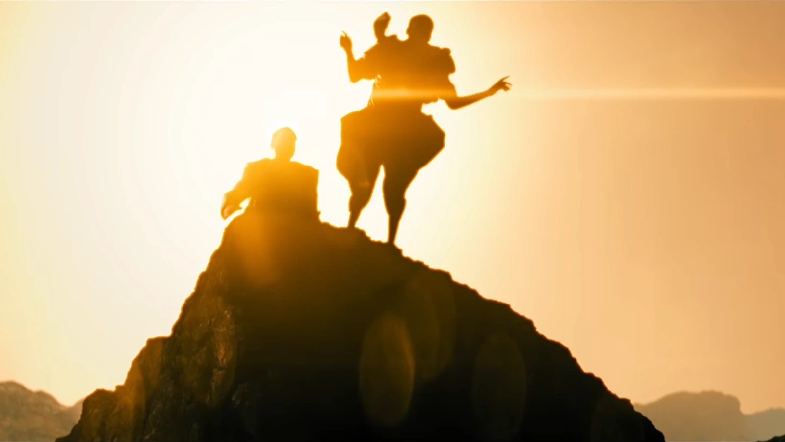 Silhouetted figures on a rocky peak against a golden sky, a Mercer-climb image from Blade Runner 2099 trailer material