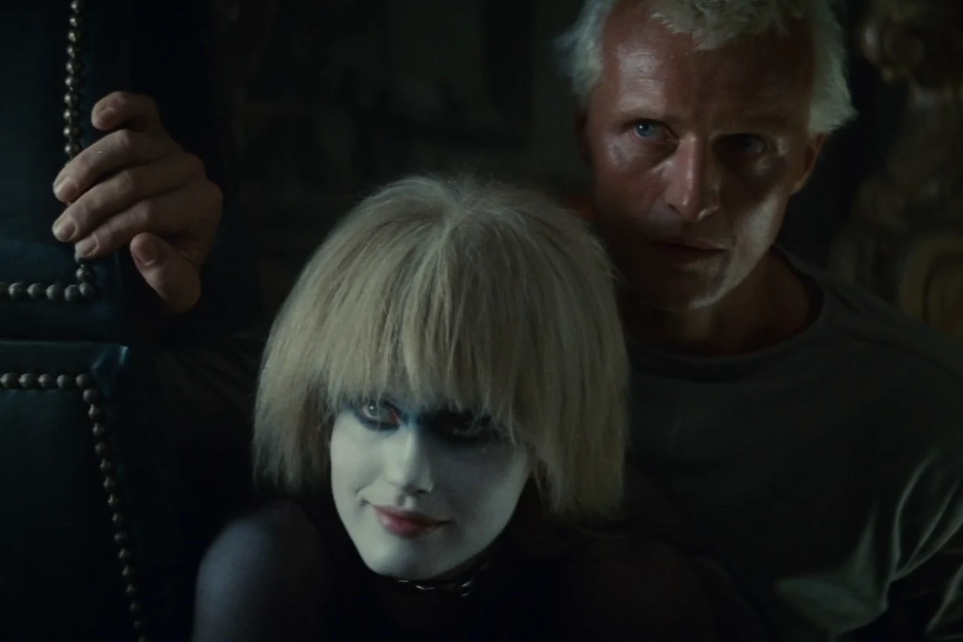 Pris in white face makeup with Roy Batty behind her in Sebastian's apartment in Blade Runner