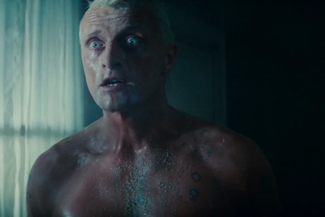 Rutger Hauer as Roy Batty, shirtless, stalking Deckard through the Bradbury Building in Blade Runner