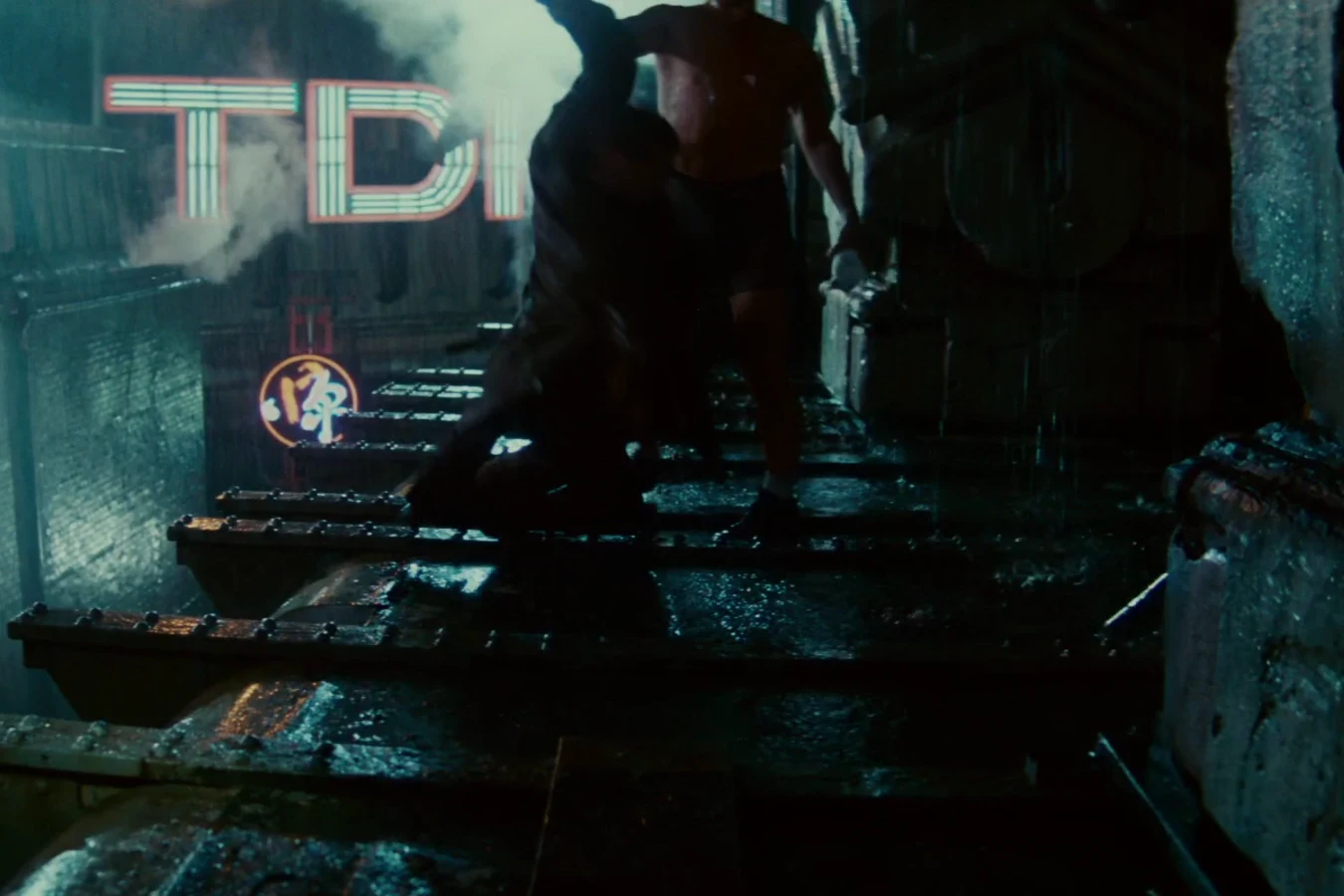 Roy Batty hauling Rick Deckard up onto the rain-soaked rooftop by one arm in Blade Runner