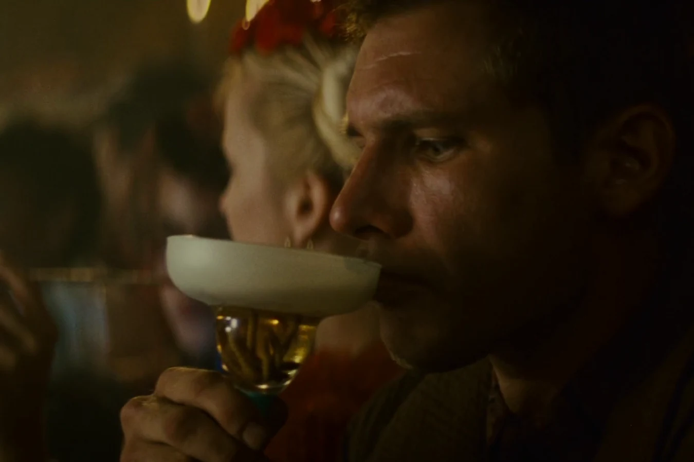 Harrison Ford as Deckard drinking from a glass at the Snake Pit bar in Blade Runner