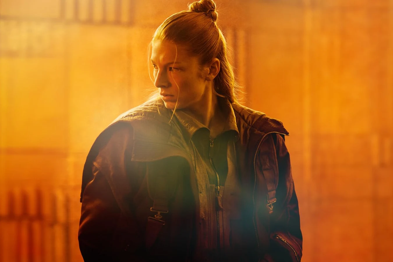 Hunter Schafer as Cora in Blade Runner 2099, standing against amber light