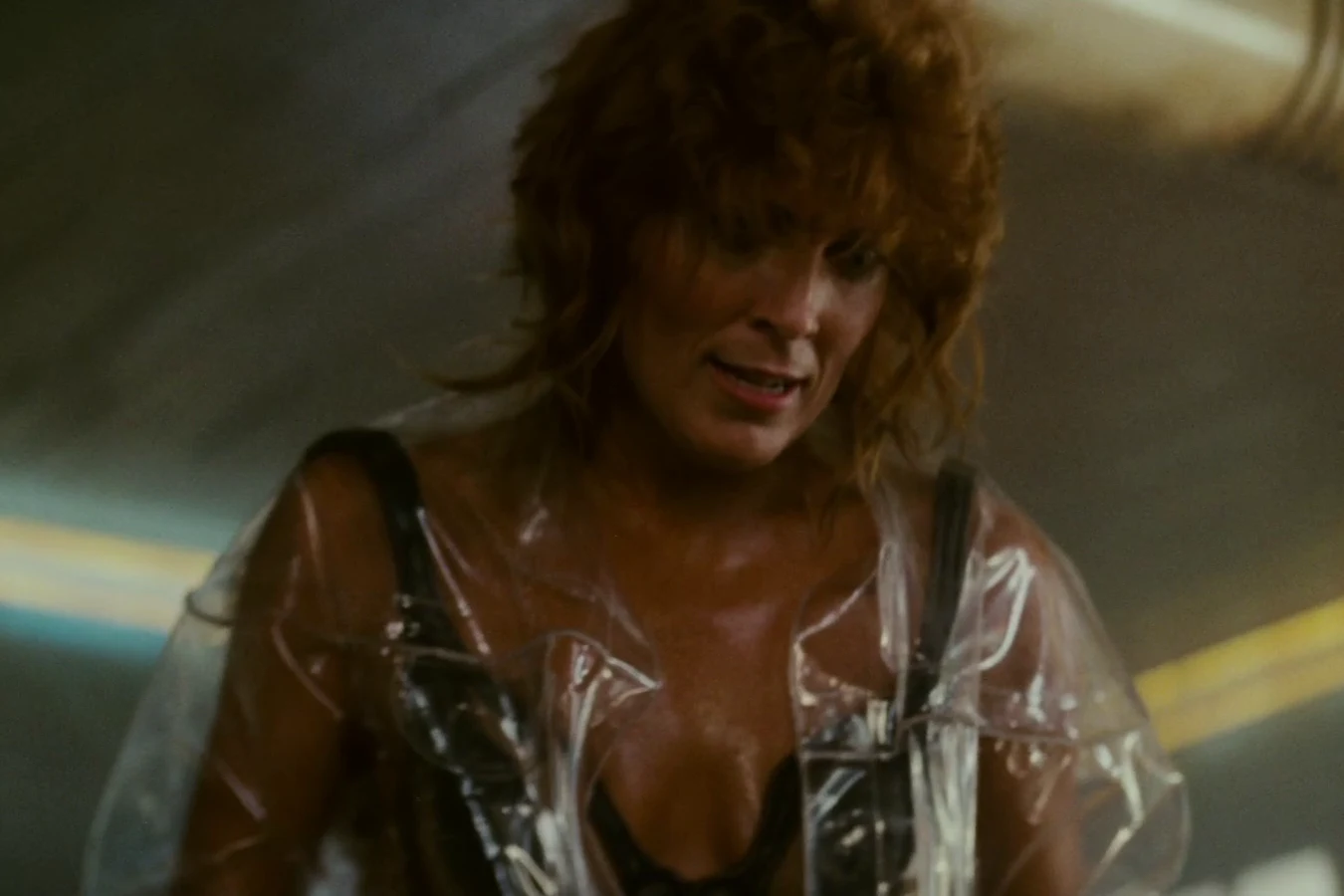 Zhora in her clear plastic raincoat glaring down at Deckard in her dressing room in Blade Runner