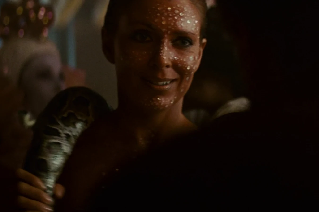 Joanna Cassidy as Zhora in sequins with her artificial python among the crowd at Taffey Lewis's club in Blade Runner