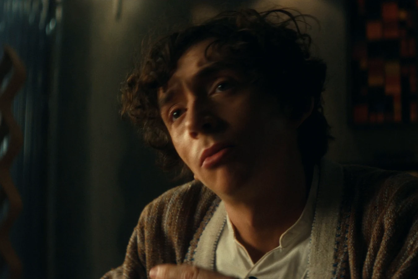 Boy Kavalier leaning in as he talks to Dame Sylvia in a dimly lit room in Alien: Earth
