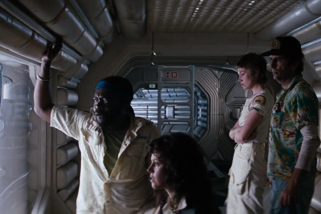 Parker, Lambert, Ripley, and Brett at a Nostromo window in Alien