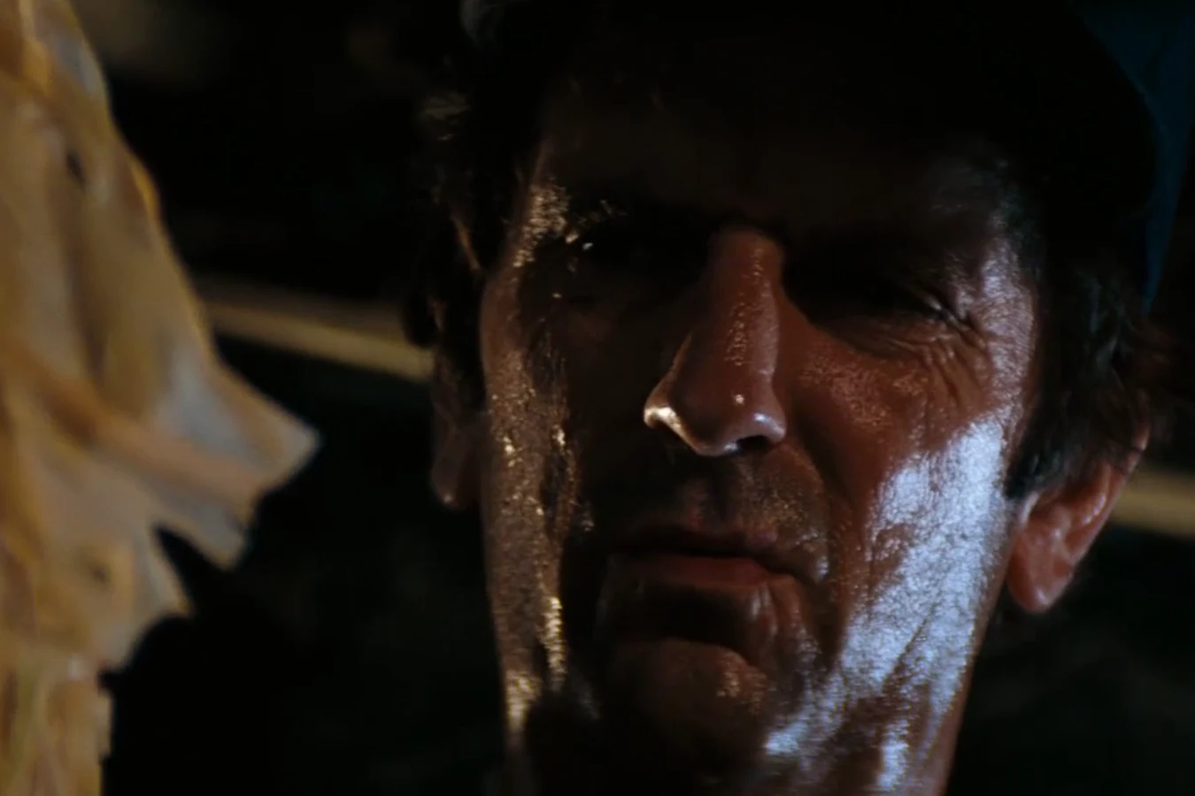 Brett lifts the Chestburster's shed skin during the search on the Nostromo