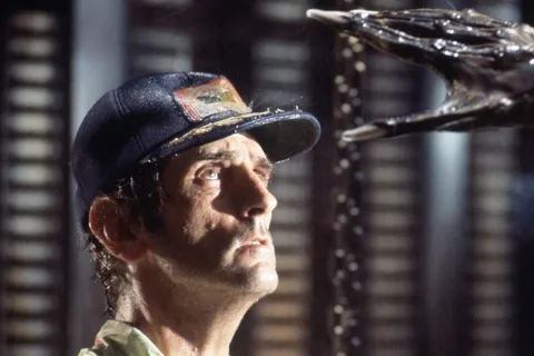 Brett looks up at the adult Xenomorph's hand in the landing-leg bay in Alien