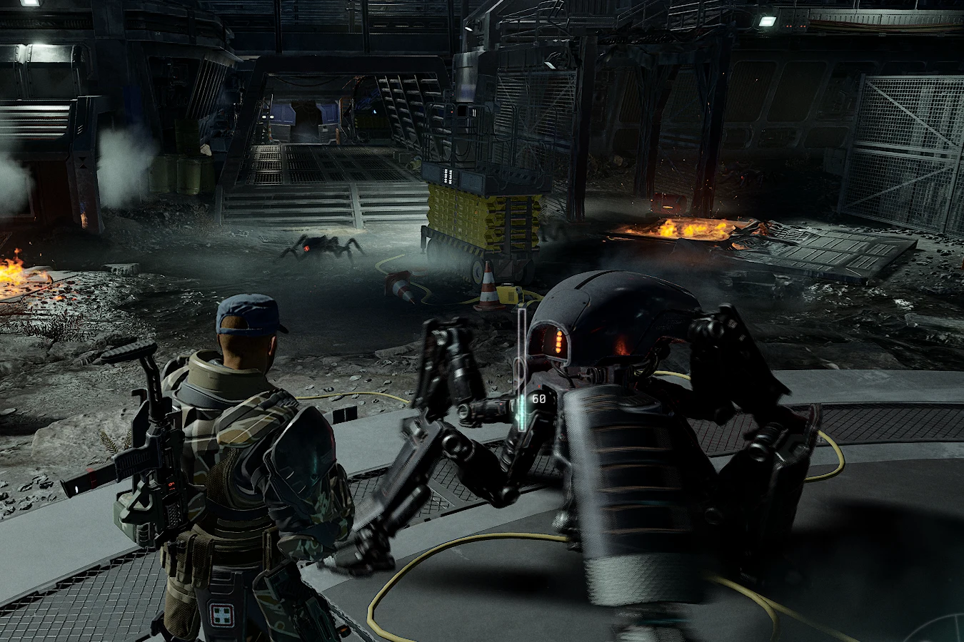 A Bulwark Combat Automaton in an industrial bay in Aliens Fireteam Elite 2
