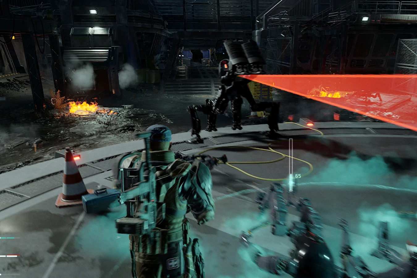 A Bulwark throwing a red targeting fan across an industrial floor in Aliens Fireteam Elite 2