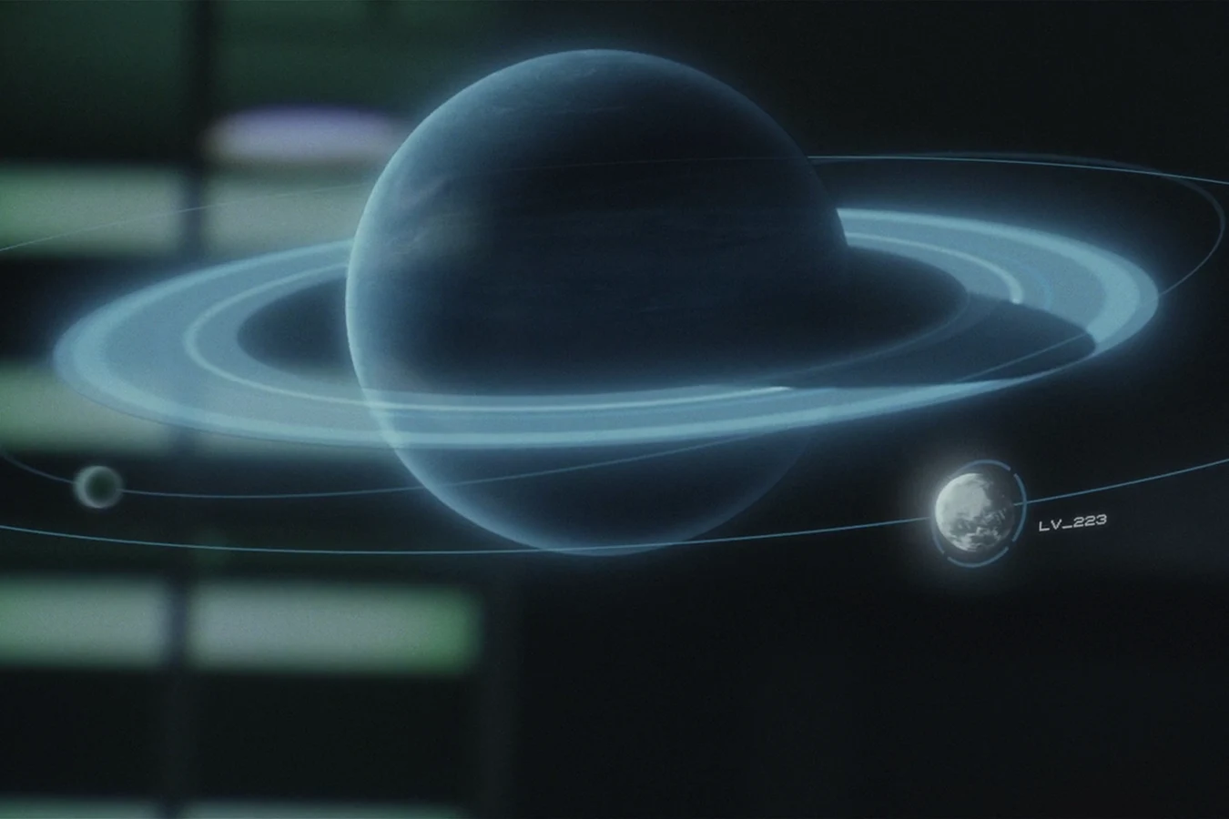 Prometheus bridge display of the ringed giant, with LV-223 tagged on one moon and a smaller moon left untagged