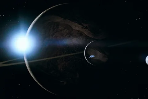 The ringed gas giant in Alien, with the Nostromo crossing a moon and LV-223 off to the side