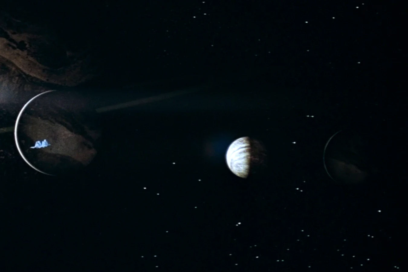 Three moons of Calpamos in Alien, with the Nostromo crossing the near moon, LV-223 in the middle, and a third moon at the right