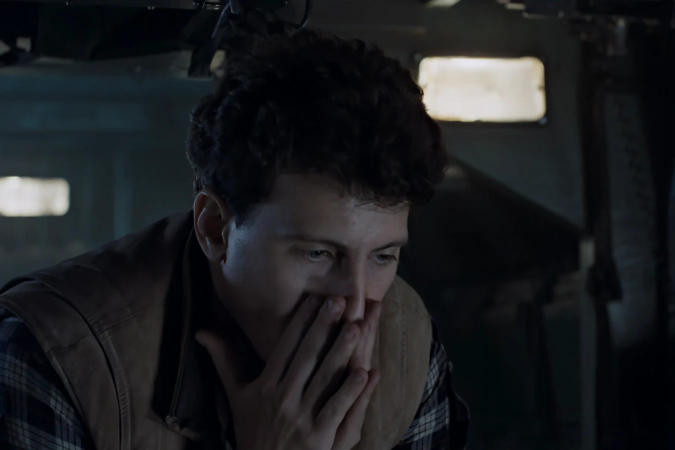 Carter Burke covering his mouth in the APC during the atmosphere processor attack in Aliens