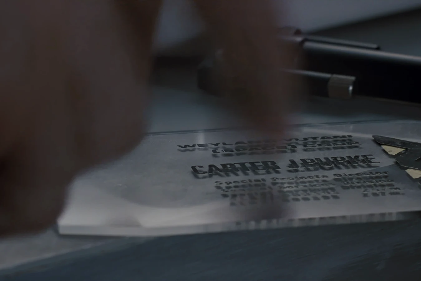 Carter J. Burke's Weyland-Yutani identification card, naming him Special Projects Director, on a table in Aliens