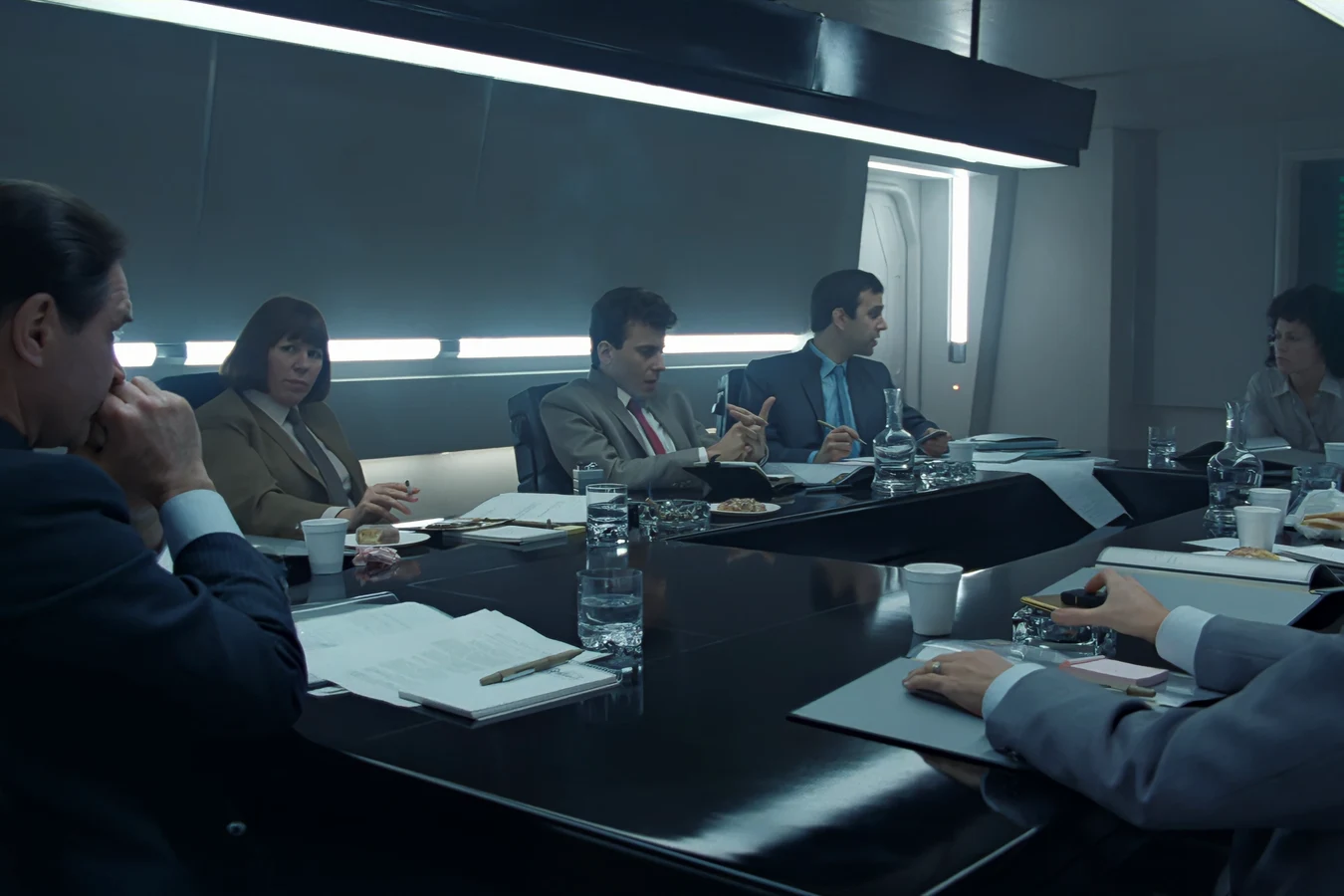 Carter Burke at the company inquiry table in Aliens, with Ripley across from him