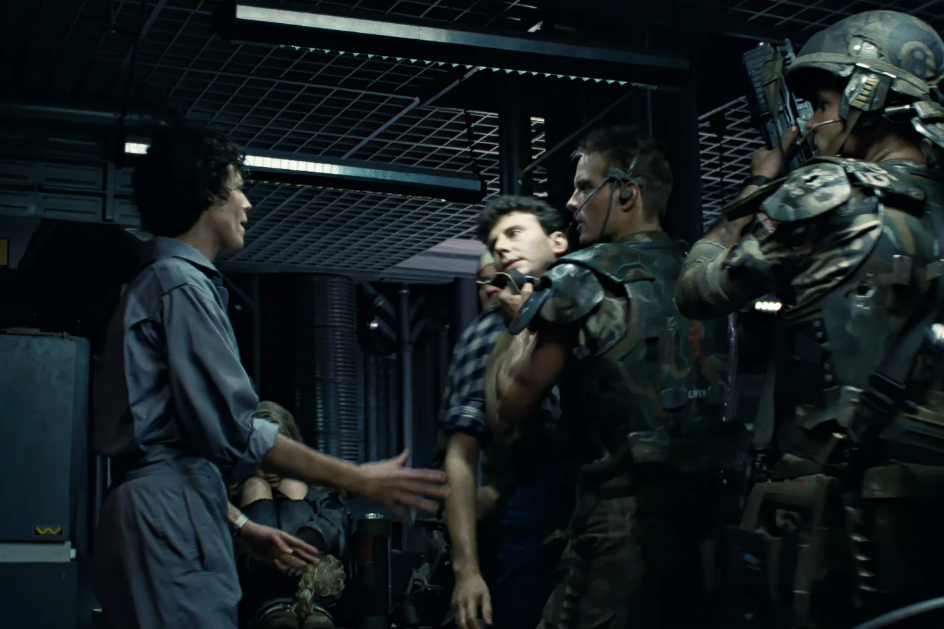 Carter Burke held by the Marines while Ellen Ripley confronts him in Operations in Aliens