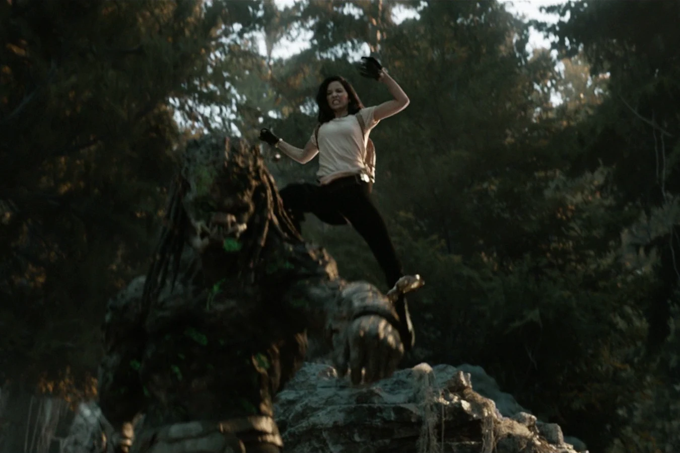 Casey Brackett attacking the Upgrade Predator from above among the trees of a dark forest
