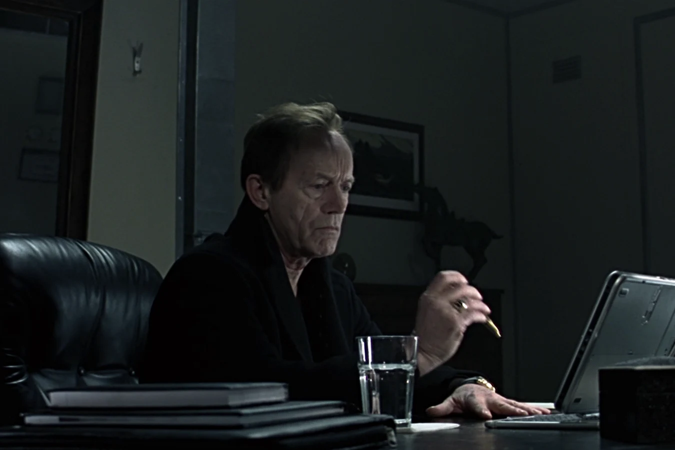 Charles Bishop Weyland at his desk with a laptop in Alien vs. Predator
