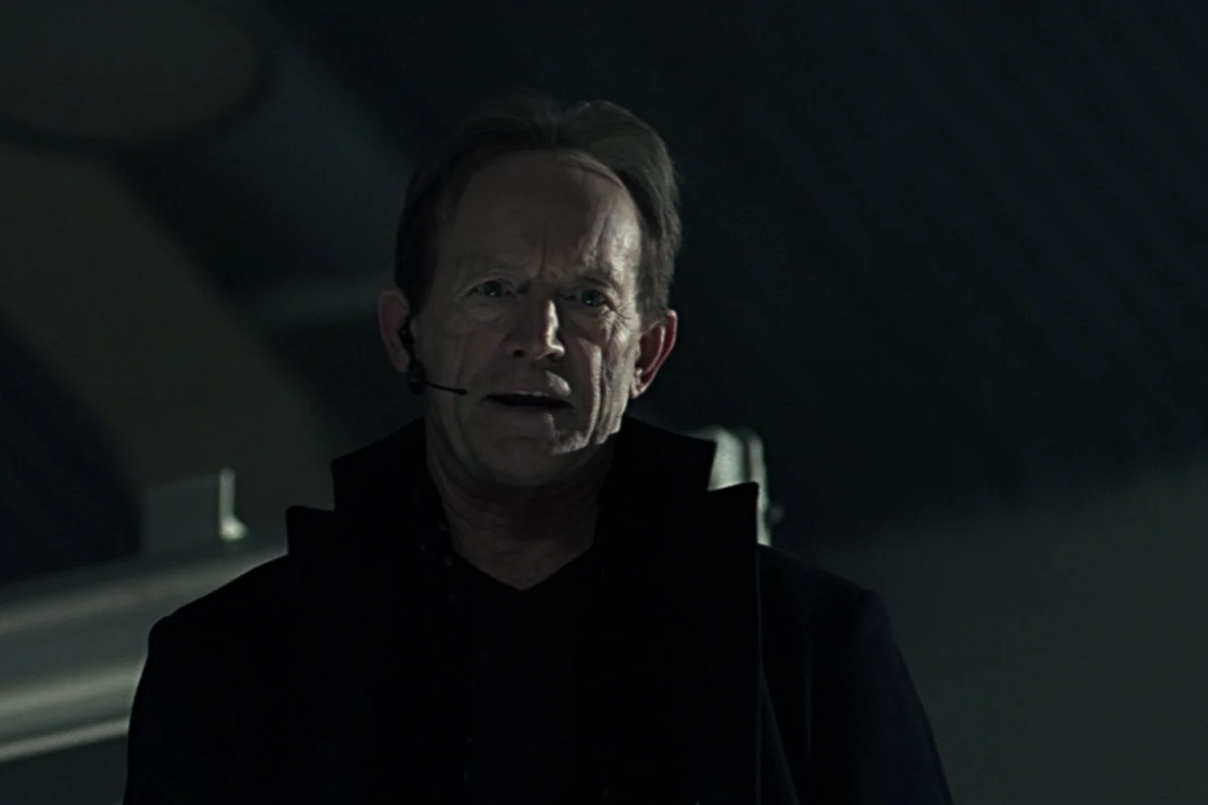 Charles Bishop Weyland speaks into a headset in Alien vs. Predator