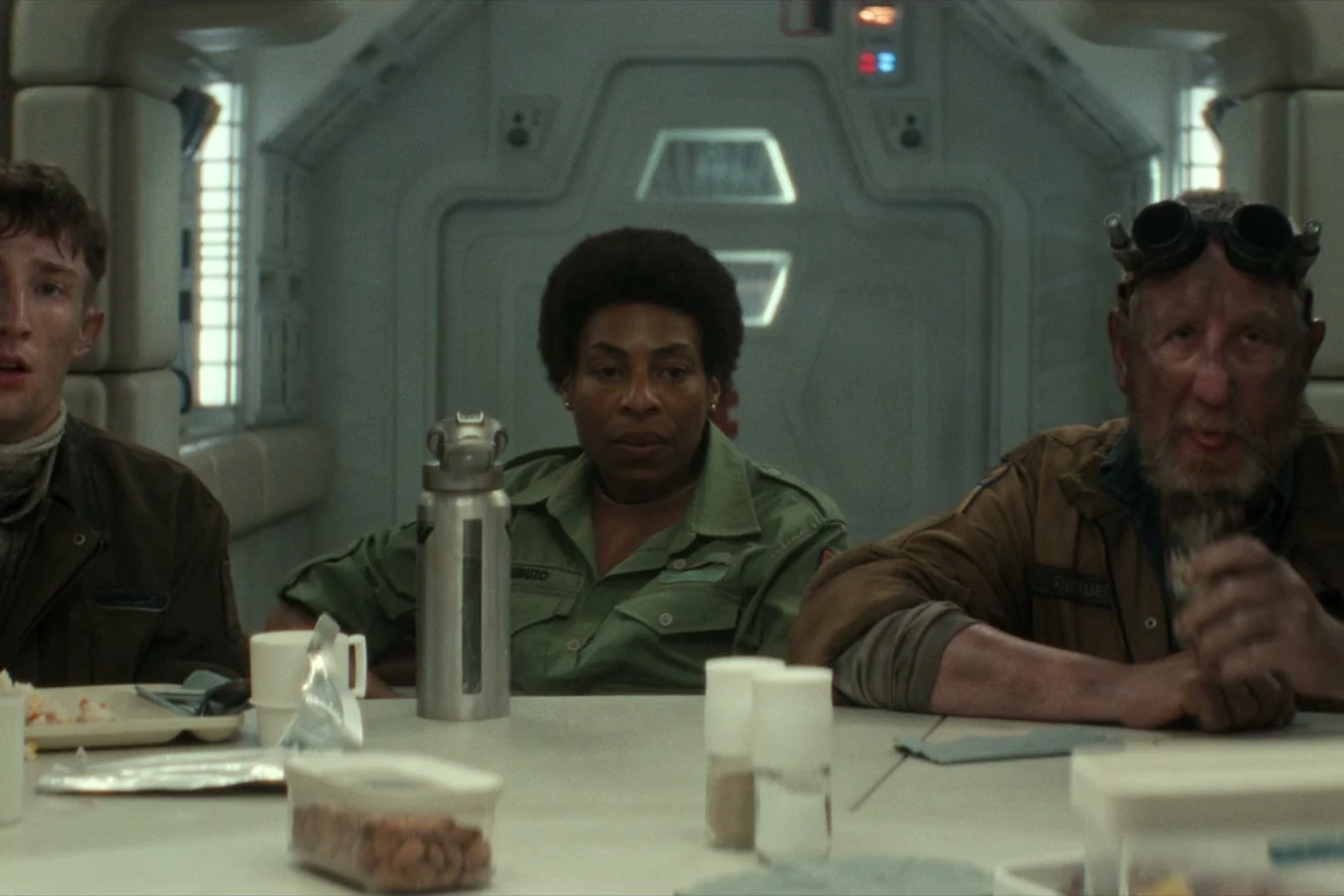 Chibuzo seated between Maginot crew at the mess hall emergency briefing in Alien: Earth
