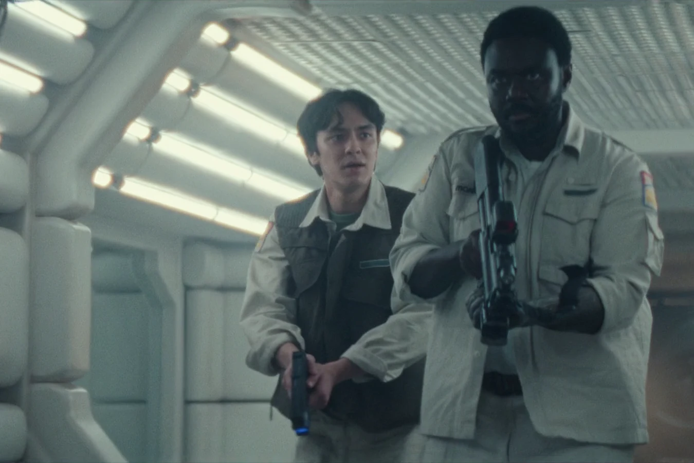 Clem Madey and Morrow moving armed through a Maginot corridor in Alien: Earth