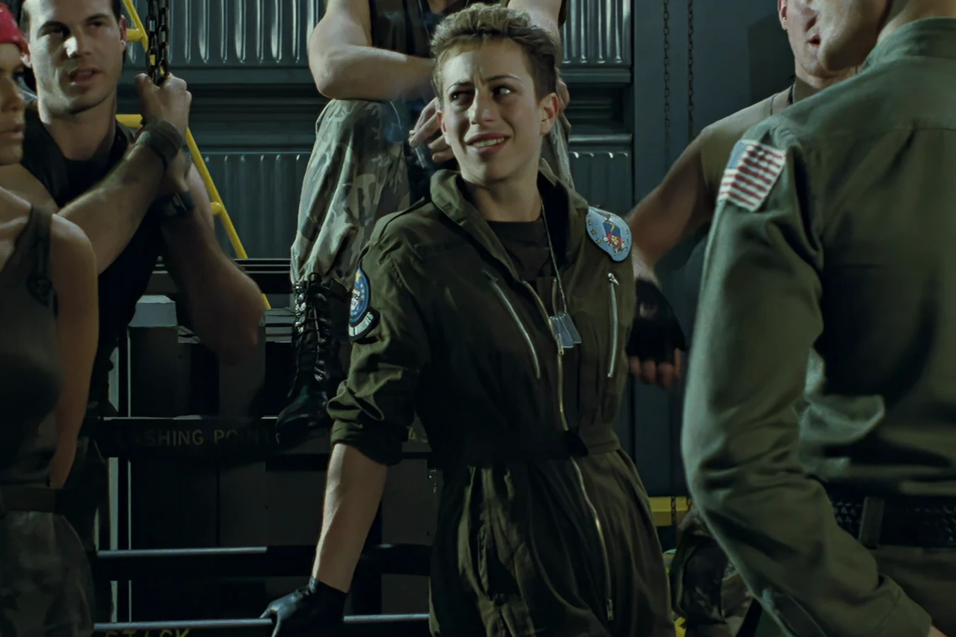 Colette Ferro in a flight suit and gloves during the Sulaco briefing in Aliens