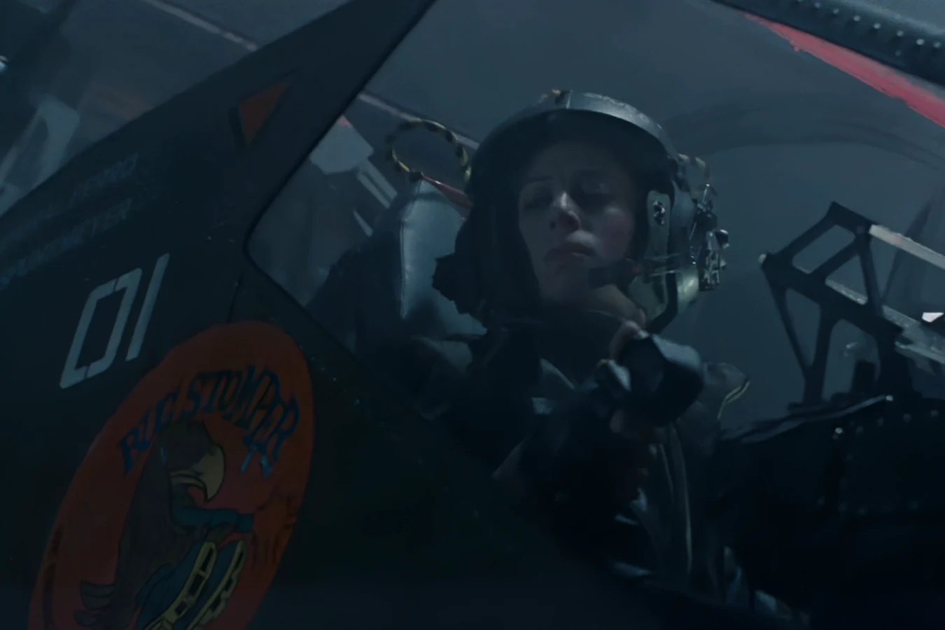Ferro at the Bug Stomper controls behind the canopy, with the orange Bug Stomper nose art and crew names on the hull in Aliens